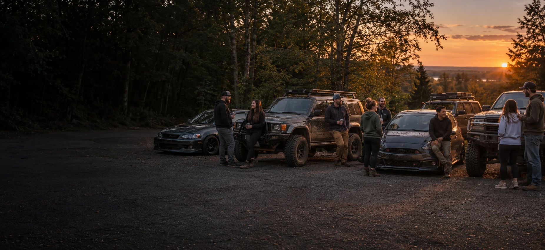 Riders hanging out at sunset by their street cars and muddy 4x4s, parked side by side